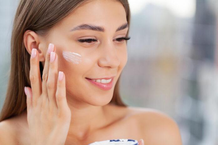 girl-applying-moisturizing-cream-her-face
