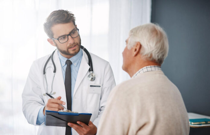 lets-set-up-appointment-week-cropped-shot-young-male-doctor-going-through-medical-records-with-his-senior-male-patient