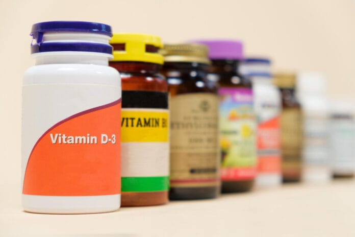 vitamin-d3-other-vitamins-beige-background
